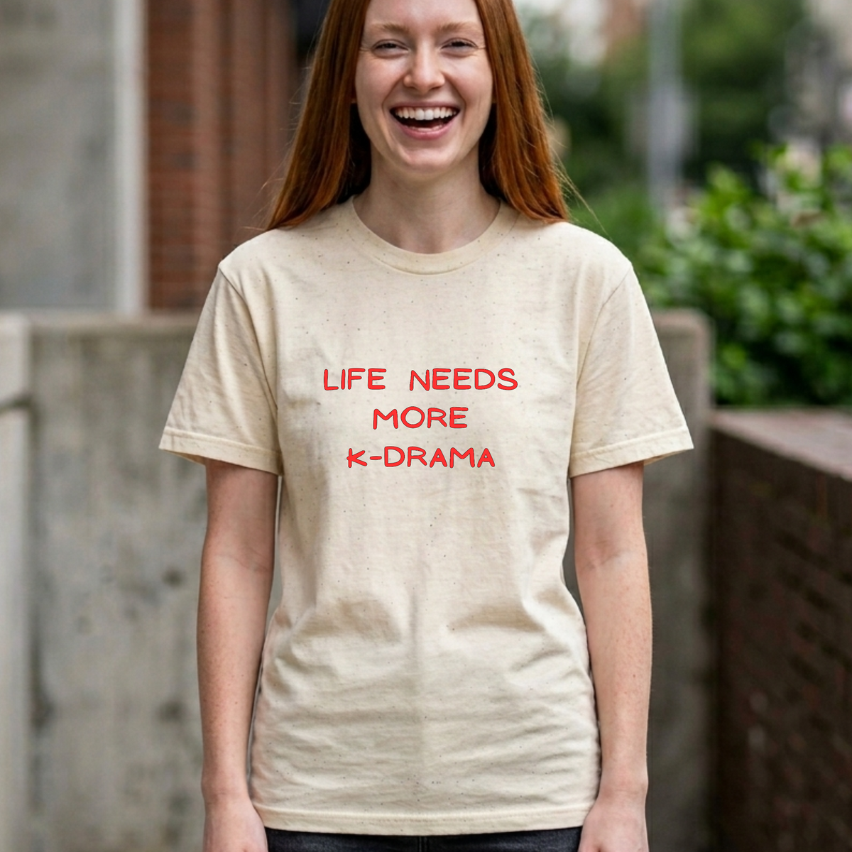 woman wearing beige t-shirt for Korean show fans with 'LIFE NEEDS MORE K-DRAMA' text by Kjota