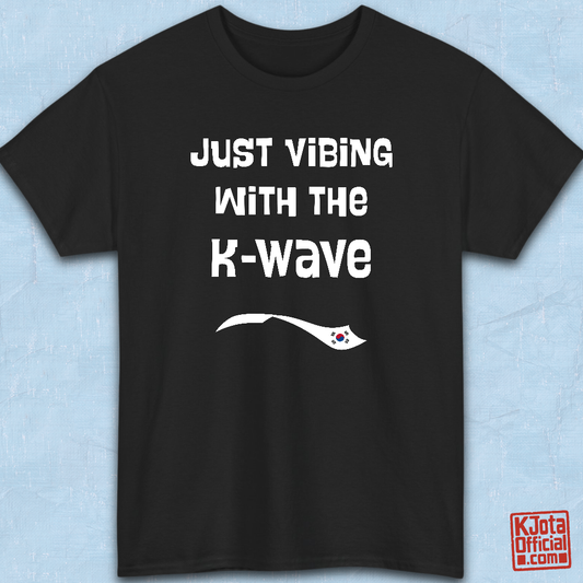 Black t-shirt flatlay with “Just vibing with the K-Wave” printed on front. Korean pop culture fandom t-shirt by K-Jota