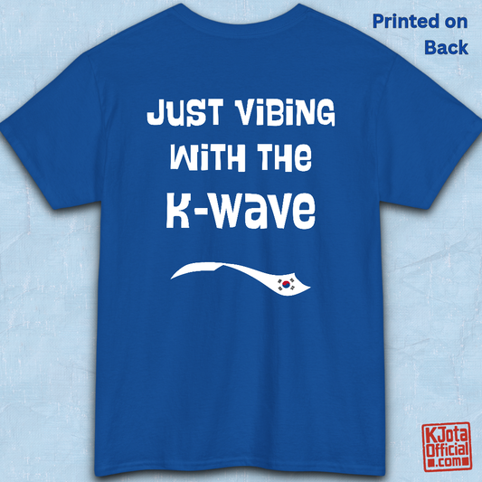 Blue t-shirt flatlay with “Just vibing with the K-Wave” printed on back. Korean pop culture fandom t-shirt by K-Jota