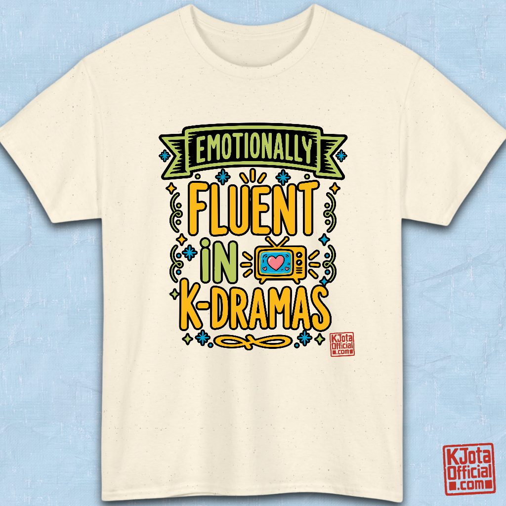 “Emotionally Fluent in K-Dramas” printed on front of tee, Korean show superfan identity binge watching t-shirt beige flatlay by K-Jota