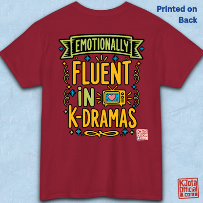 “Emotionally Fluent in K-Dramas” printed on front of tee, Korean show superfan identity binge watching t-shirt red backside flatlay by K-Jota