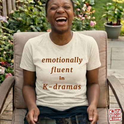 female fan wearing “emotionally fluent in K-dramas” printed on front of tee, Korean show superfan identity binge watching outfit beige t-shirt by K-Jota