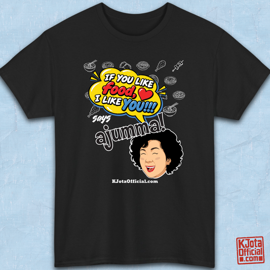black t-shirt flatlay with a comic-style yellow speech bubble reading 'If You Like Food, I Like You!!!' above a laughing Korean ajumma illustration and hand-drawn Korean food icons by K-Jota