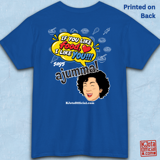blue t-shirt backside flatlay with a comic-style yellow speech bubble reading 'If You Like Food, I Like You!!!' above a laughing Korean ajumma illustration and hand-drawn Korean food icons by K-Jota