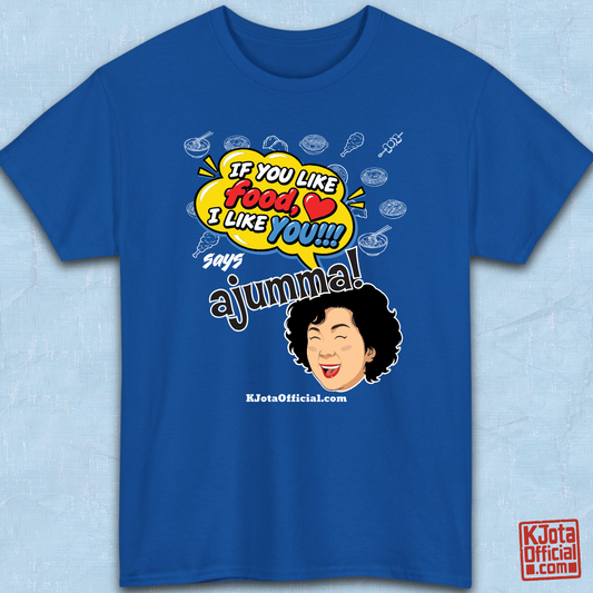 blue t-shirt flatlay with a comic-style yellow speech bubble reading 'If You Like Food, I Like You!!!' above a laughing Korean ajumma illustration and hand-drawn Korean food icons by K-Jota
