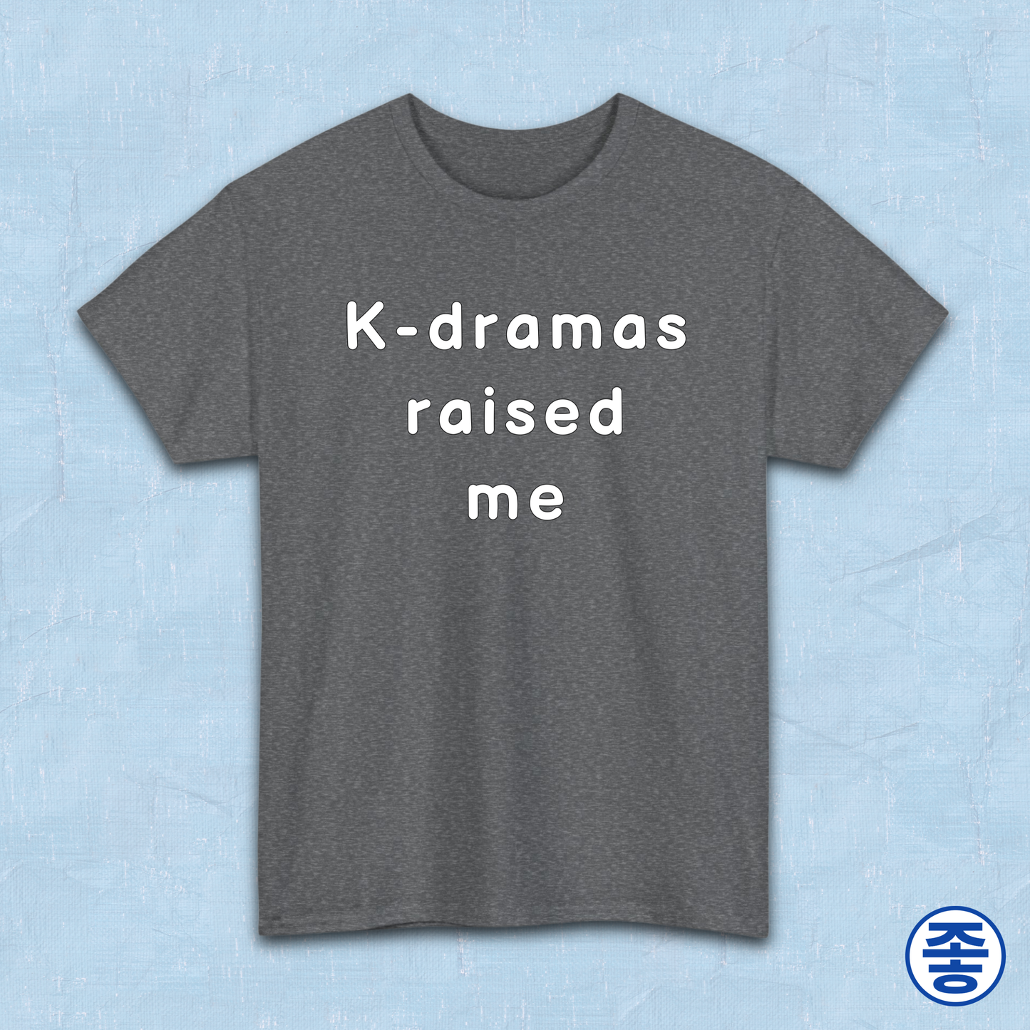 Gray t-shirt for Korean show fans with 'K-dramas raised me' text on a light blue background by Kjota