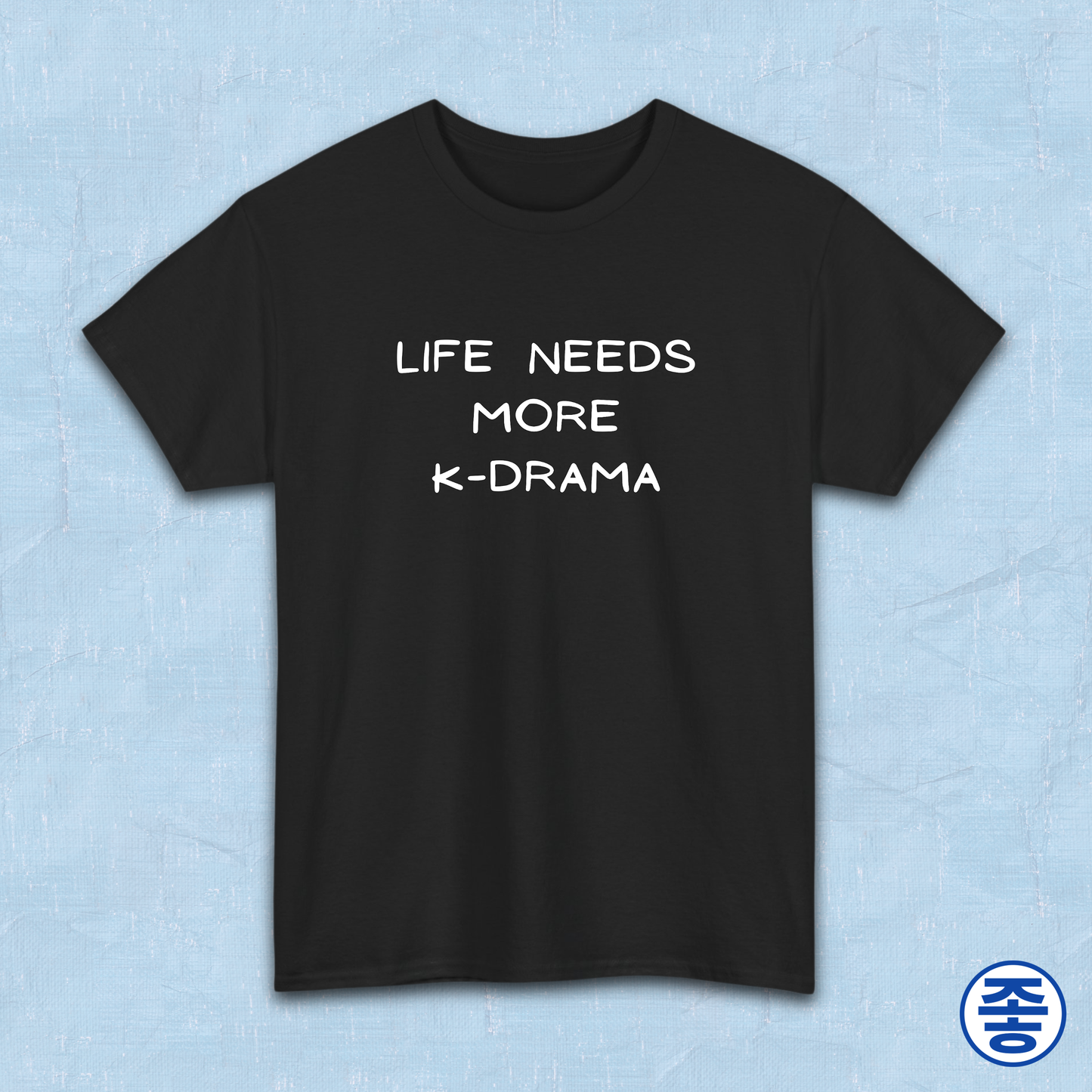 Black t-shirt for Korean show fans with 'LIFE NEEDS MORE K-DRAMA' text on a light blue background by Kjota
