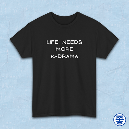 Black t-shirt for Korean show fans with 'LIFE NEEDS MORE K-DRAMA' text on a light blue background by Kjota