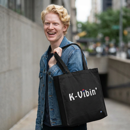 man holding K-Vibin’ Korean culture fandom wave black canvas bag by Kjota 
