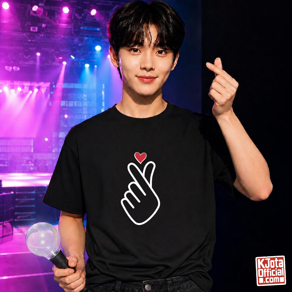 man wearing finger heart Korean saranghaeyo I love you K-pop fan t-shirt black by K-Jota and making finger heart gesture in one hand and holding a light stick in the other at a concert venue