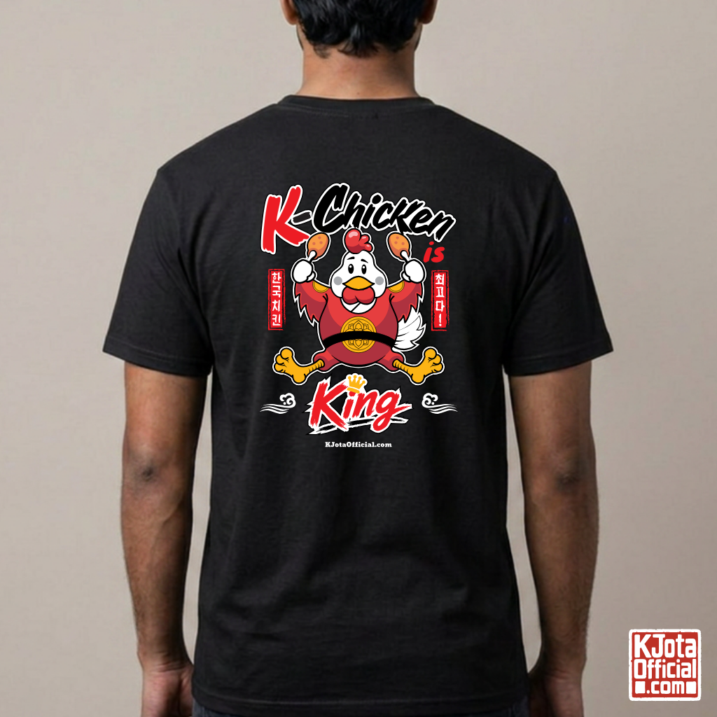 man wearing “K-Chicken is King” graphic black t-shirt featuring a Korean chicken mascot wearing a red royal robe and holding fried chicken drumsticks with Hangeul text printed on back of tee by K-Jota