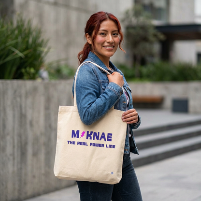 woman holding a Maknae K-pop fan beige canvas tote bag for photocard trading events by Kjota