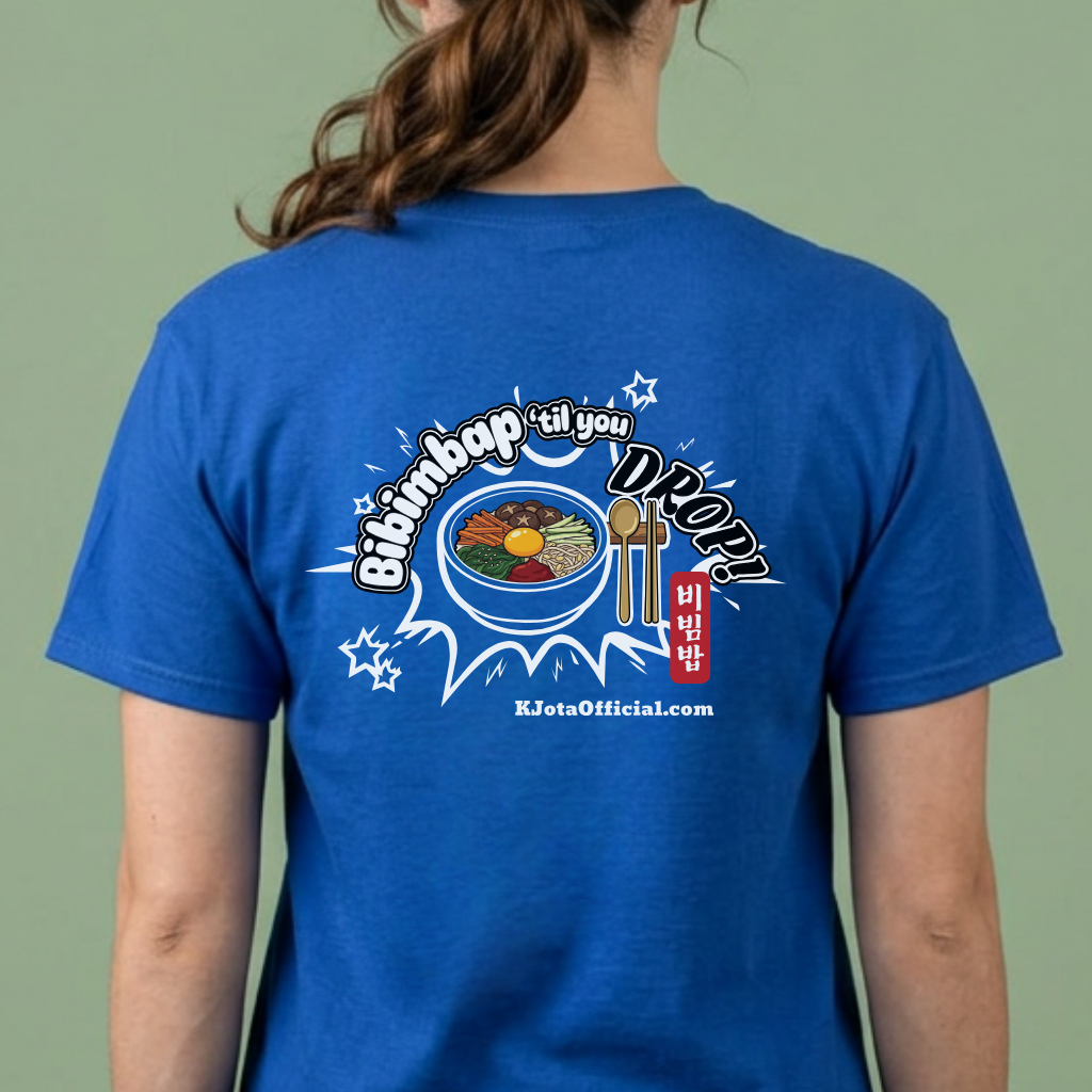 A woman wearing a blue t-shirt by K-Jota showing a graphic printed on the back.  The graphic features a hand-illustrated bowl of bibimbap with a spoon and chopsticks, and texts “Bibimbap ‘til You Drop 비빔밥” and “KJotaOfficial.com”.