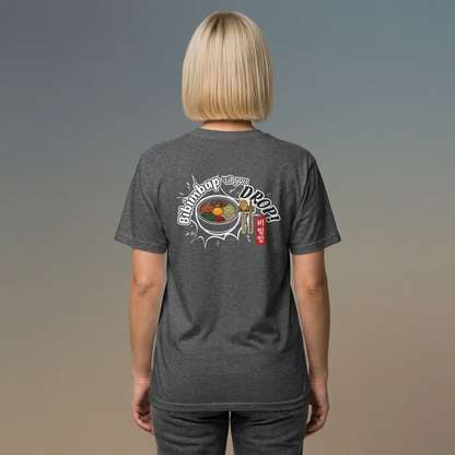 A woman viewed from behind wearing a gray Korean food fan t-shirt by Kjota with a graphic on the back. The graphic features a bowl of bibimbap with a spoon and chopsticks, and text “Bibimbap ‘til You Drop 비빔밥”