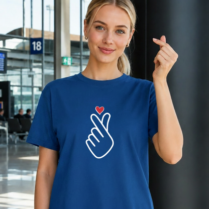 woman wearing finger heart Korean saranghaeyo I love you K-pop Hallyu fan t-shirt blue by K-Jota and making finger heart gesture at airport
