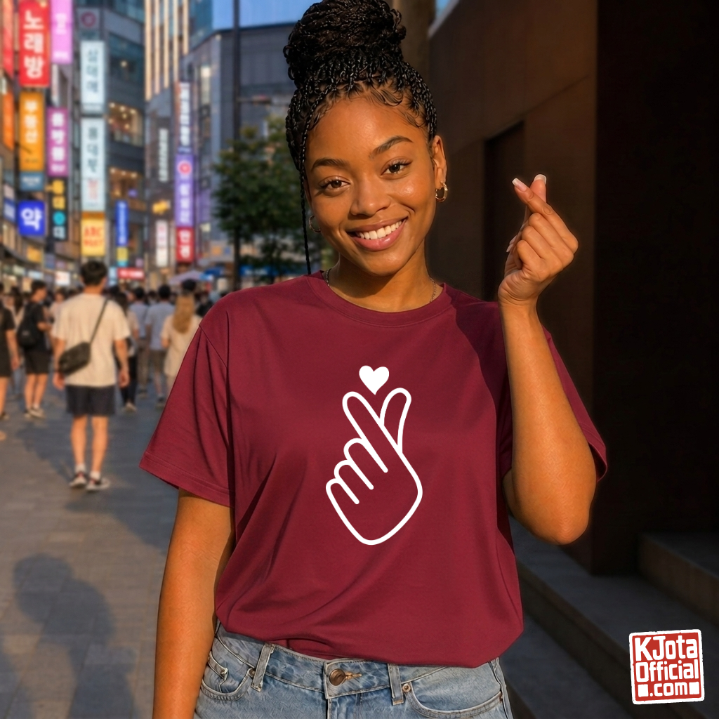 woman wearing finger heart Korean saranghaeyo I love you K-pop fan t-shirt red by K-Jota and making finger heart gesture in Korean city street