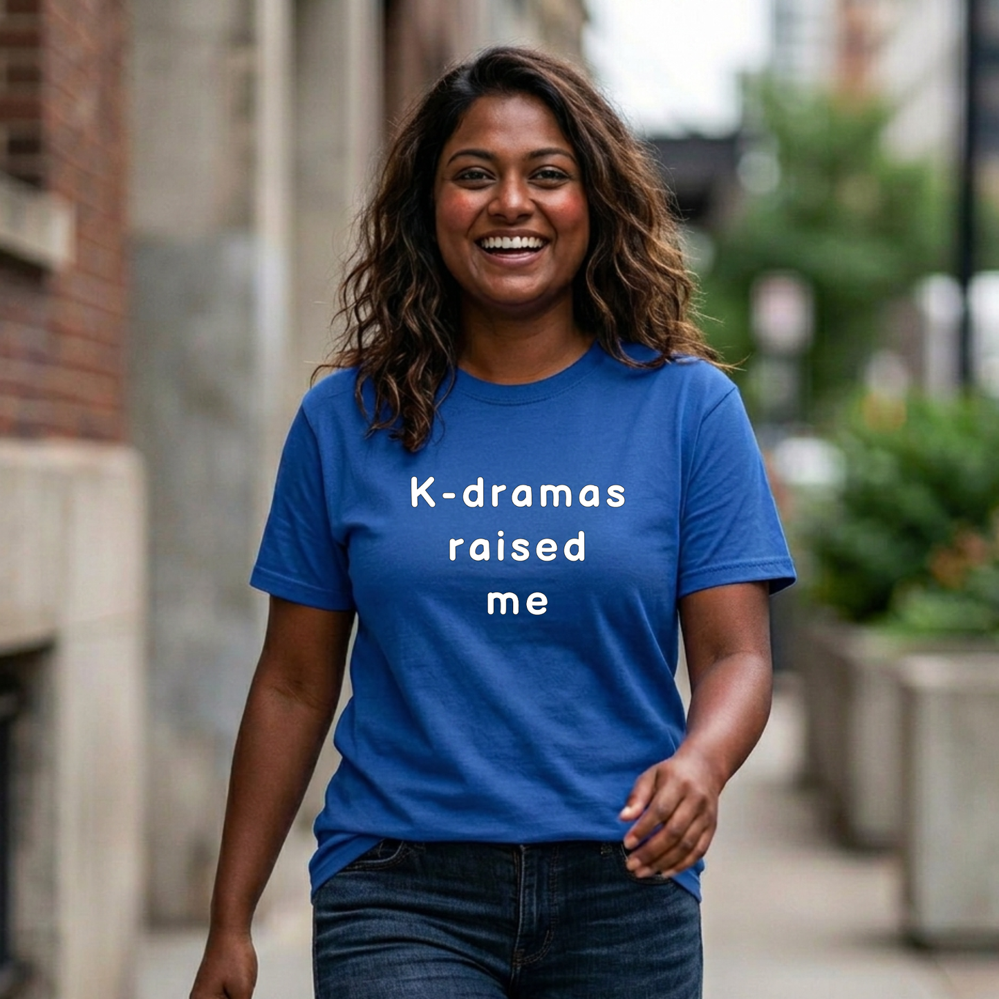 woman wearing blue t-shirt for Korean show fans with 'K-dramas raised me' text by Kjota