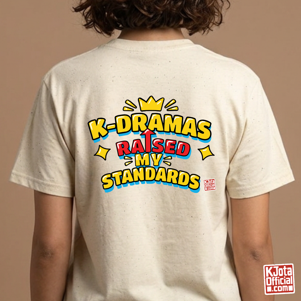 woman wearing a beige t-shirt with 'K-DRAMAS RAISED MY STANDARDS' printed on the back. Realistic expectations K-fan graphic tee by K-Jota
