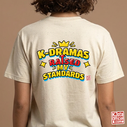 woman wearing a beige t-shirt with 'K-DRAMAS RAISED MY STANDARDS' printed on the back. Realistic expectations K-fan graphic tee by K-Jota