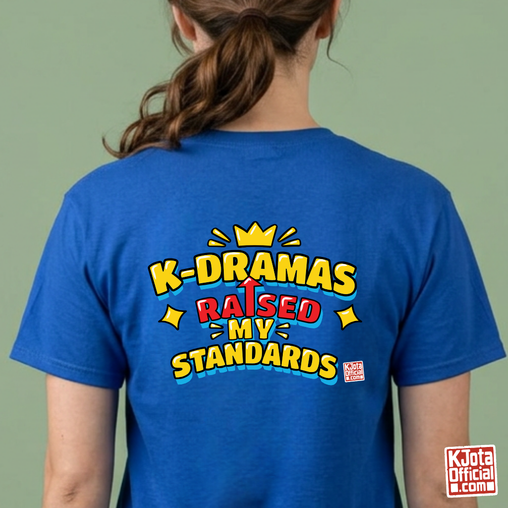 woman wearing a blue t-shirt with 'K-DRAMAS RAISED MY STANDARDS' printed on the back. Realistic expectations K-fan graphic tee by K-Jota