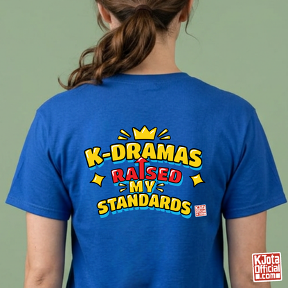 woman wearing a blue t-shirt with 'K-DRAMAS RAISED MY STANDARDS' printed on the back. Realistic expectations K-fan graphic tee by K-Jota