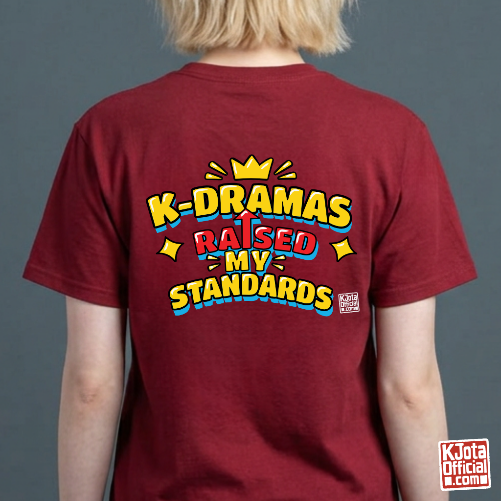 woman wearing a red t-shirt with 'K-DRAMAS RAISED MY STANDARDS' printed on the back. Realistic expectations K-fan graphic tee by K-Jota