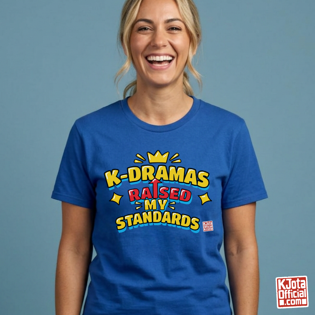 woman wearing a blue t-shirt with 'K-DRAMAS RAISED MY STANDARDS' printed on the front. Realistic expectations K-fan graphic tee by K-Jota