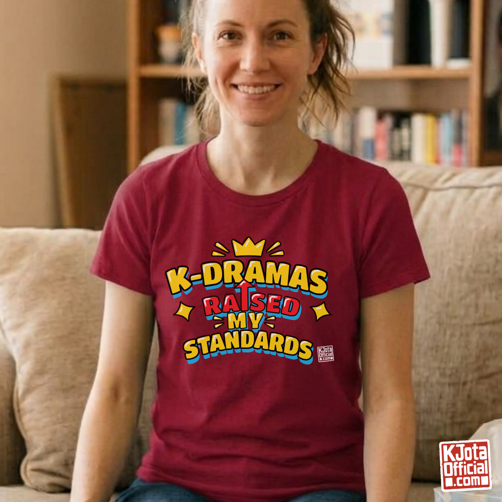 woman wearing a red t-shirt with 'K-DRAMAS RAISED MY STANDARDS' printed on the front. Realistic expectations K-fan graphic tee by K-Jota