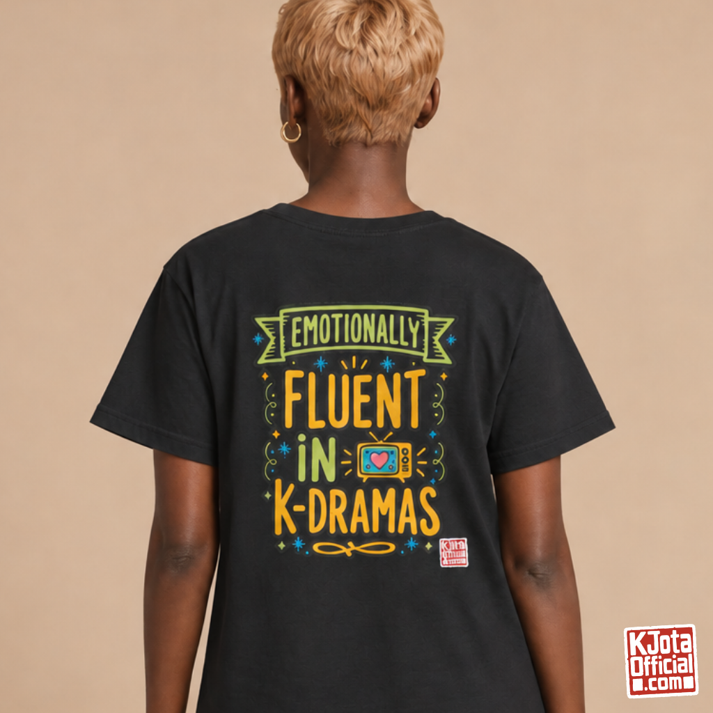 Woman wearing a black tee with “Emotionally Fluent in K-Dramas” printed on back, Korean show superfan identity binge watching t-shirt by K-Jota