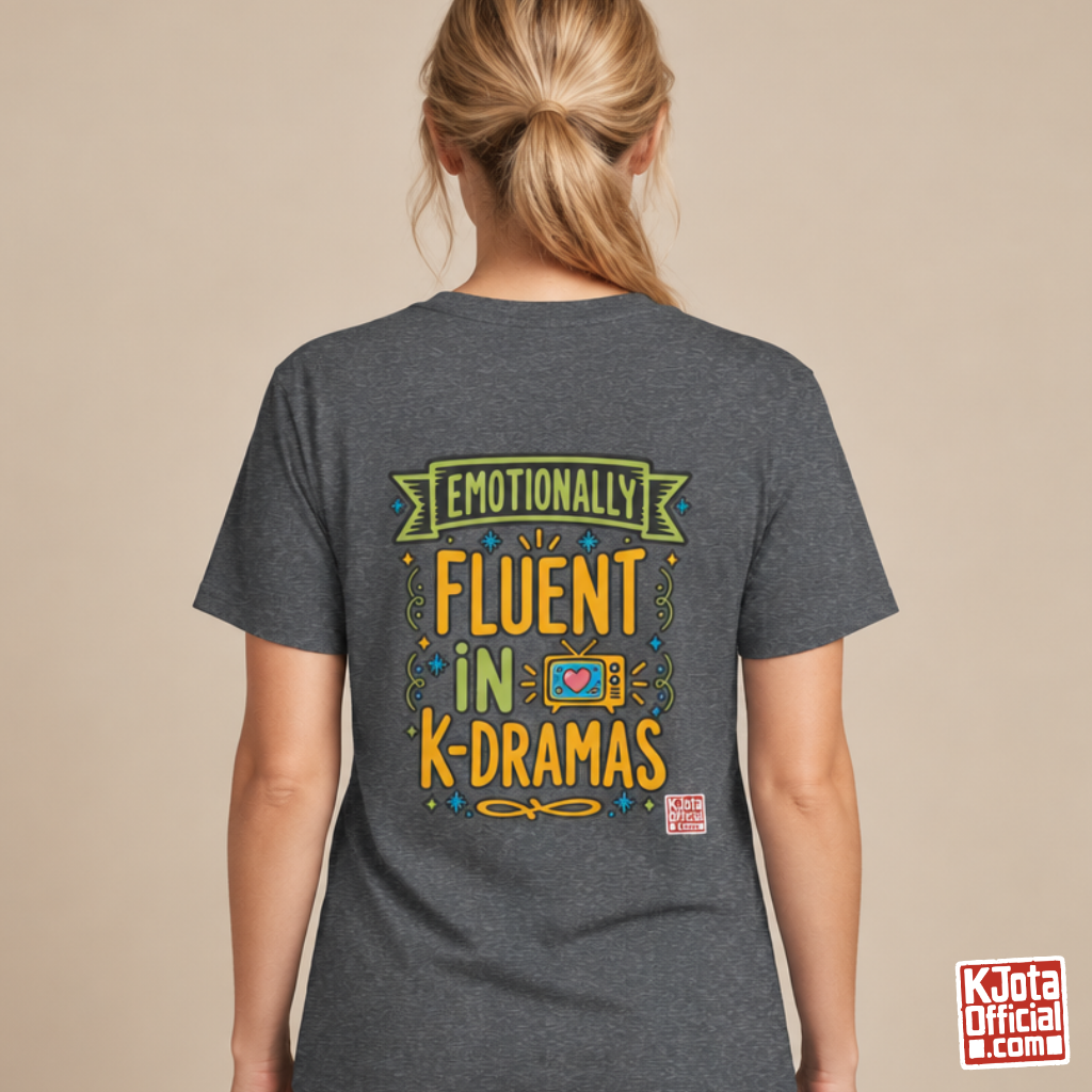 Woman wearing a gray tee with “Emotionally Fluent in K-Dramas” printed on back, Korean show superfan identity binge watching t-shirt by K-Jota
