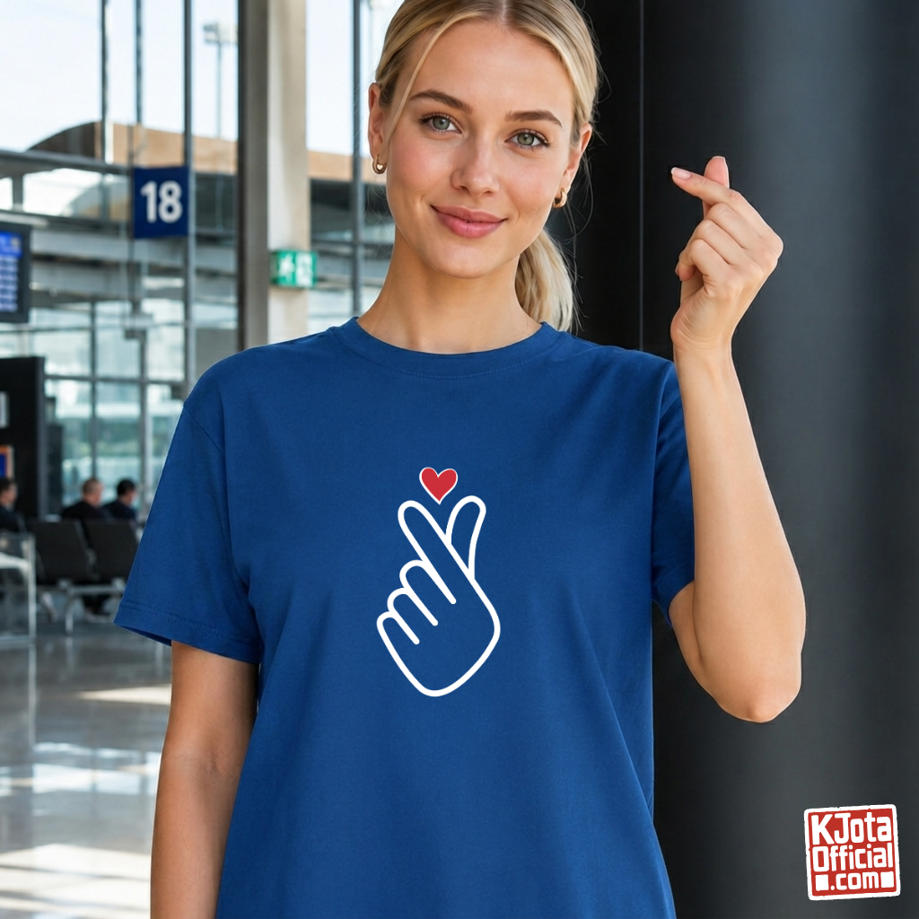 woman wearing finger heart Korean saranghaeyo I love you K-pop t-shirt blue by K-Jota and making finger heart gesture at airport