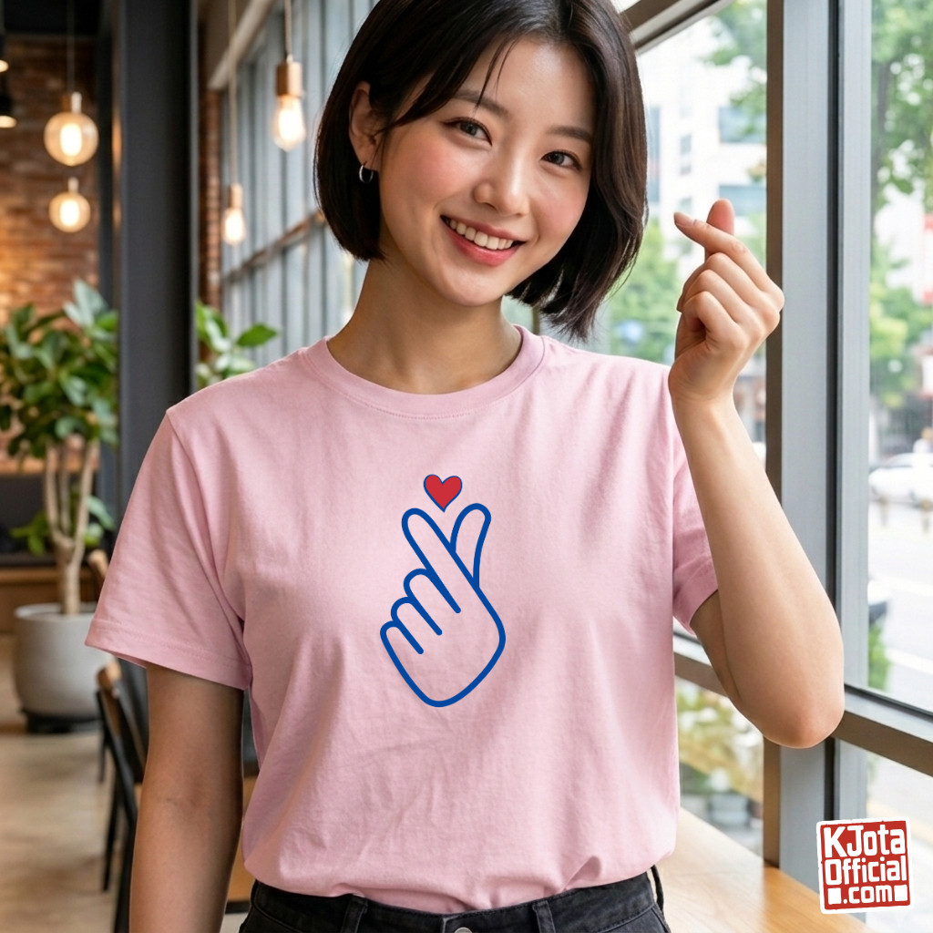 woman wearing finger heart Korean saranghaeyo I love you K-pop t-shirt pink by K-Jota and making finger heart gesture at a modern cafe