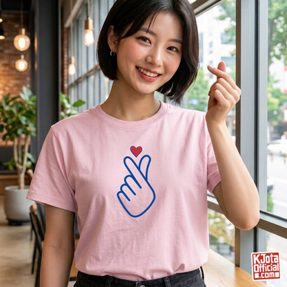 woman wearing finger heart Korean saranghaeyo I love you K-pop t-shirt pink by K-Jota and making finger heart gesture at a modern cafe